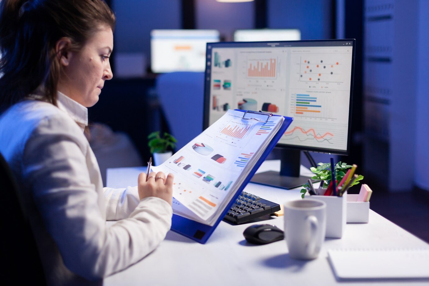 freelancer-woman-comparing-graphics-from-clipboard-with-grafics-from-computer-business-office_482257-5156